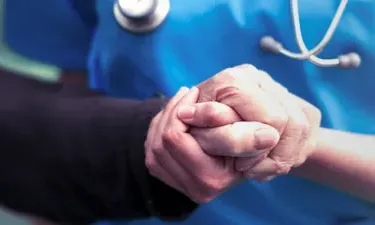 Psychiatric Mental Health Nurse Practitioner Holding Hands with Patient